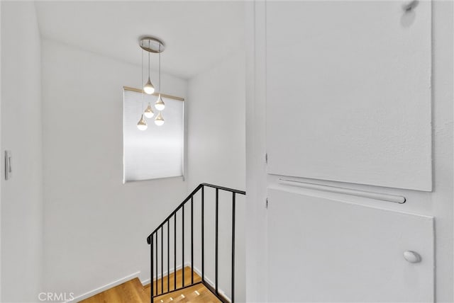 stairs featuring hardwood / wood-style flooring