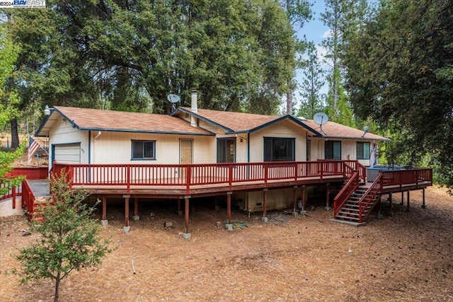 rear view of property with a wooden deck