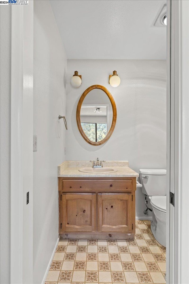 bathroom with vanity and toilet