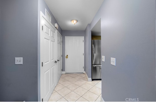 hallway featuring light tile patterned floors