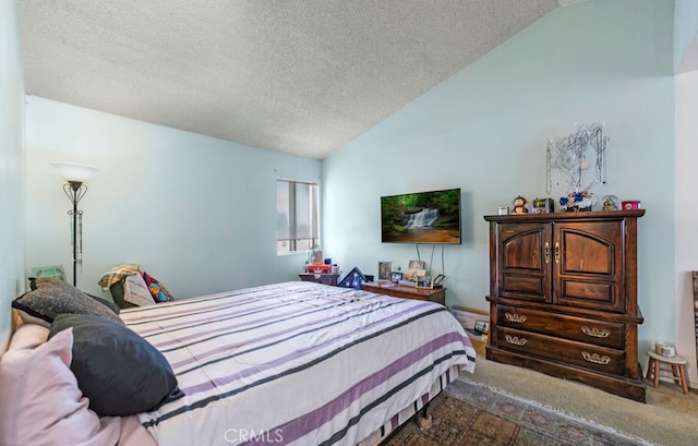 carpeted bedroom with a textured ceiling and lofted ceiling