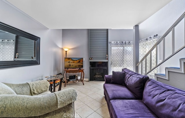 living room with a fireplace and light tile patterned floors