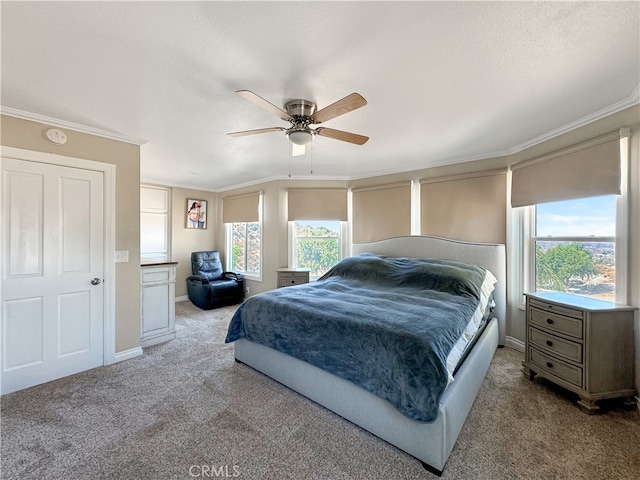 carpeted bedroom with ornamental molding, ceiling fan, multiple windows, and a textured ceiling