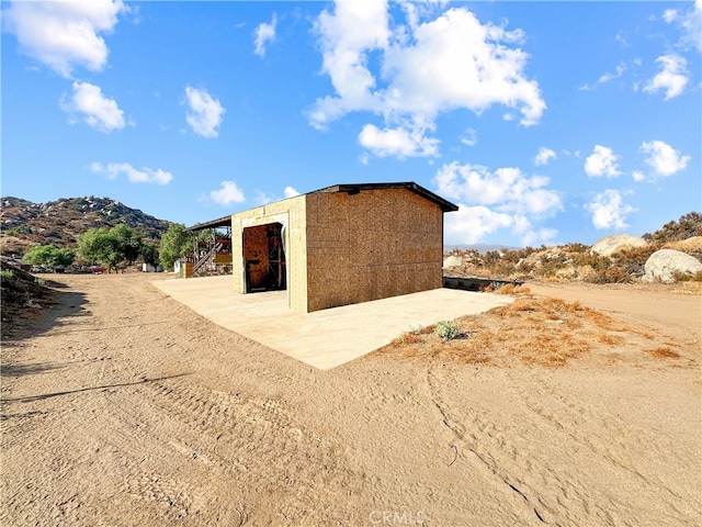 view of outbuilding featuring a mountain view