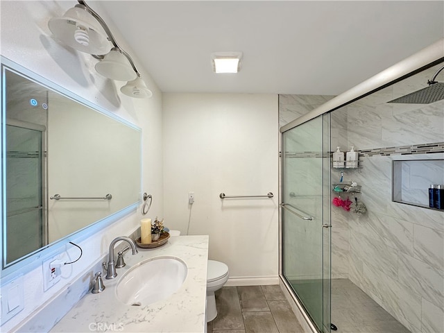 bathroom featuring vanity, toilet, and an enclosed shower