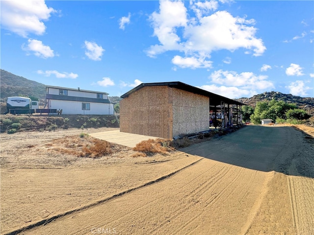 view of side of home with a mountain view