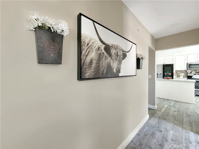 hall with hardwood / wood-style floors