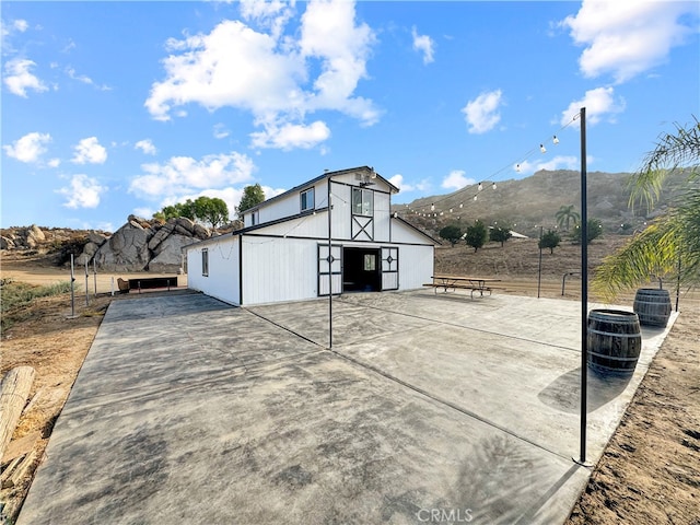 exterior space featuring a mountain view, a garage, and an outbuilding