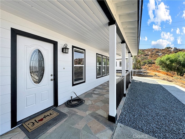 entrance to property featuring covered porch