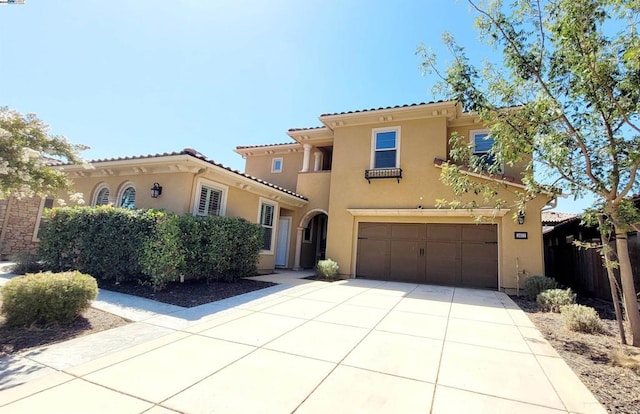 mediterranean / spanish-style home with a garage