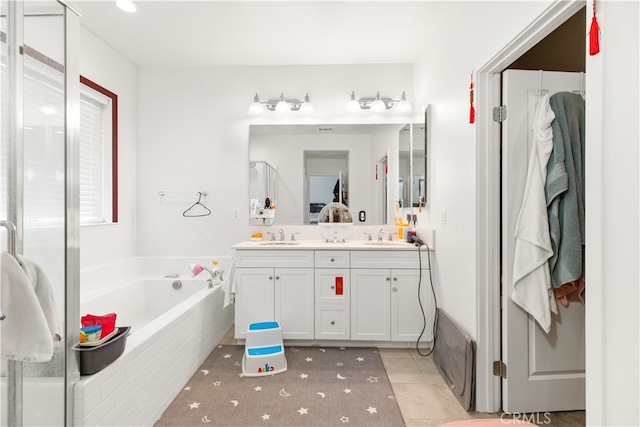 bathroom with independent shower and bath, vanity, and tile patterned flooring