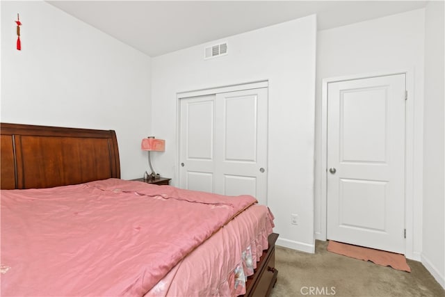 carpeted bedroom with a closet