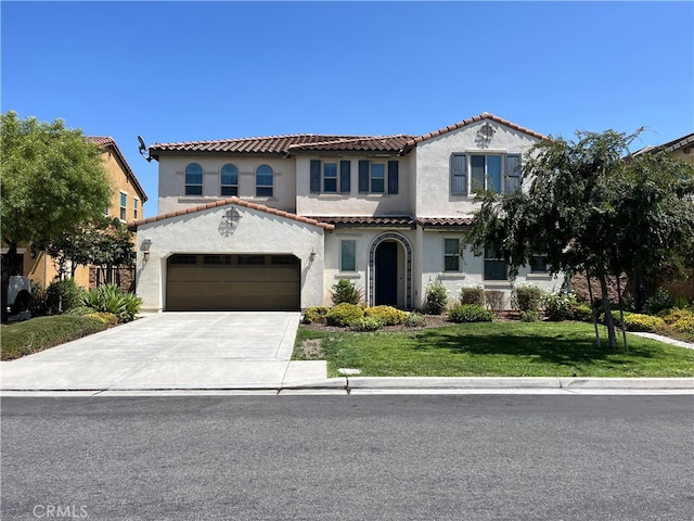 mediterranean / spanish-style home featuring a garage and a front yard