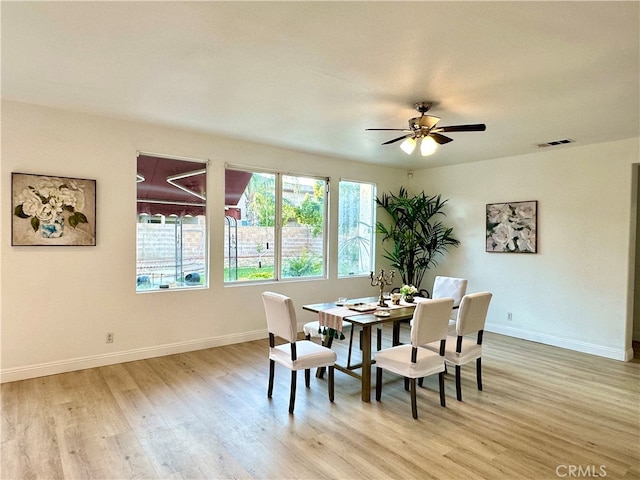 dining space with ceiling fan and light hardwood / wood-style floors