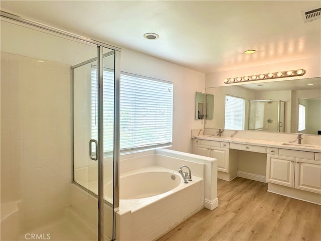 bathroom with independent shower and bath, vanity, and wood-type flooring