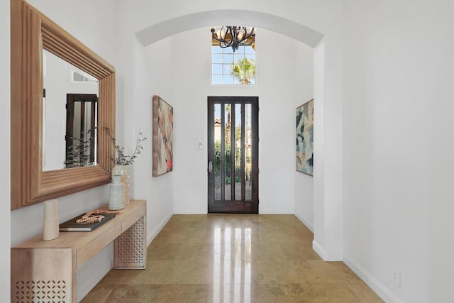 foyer with a chandelier and a high ceiling