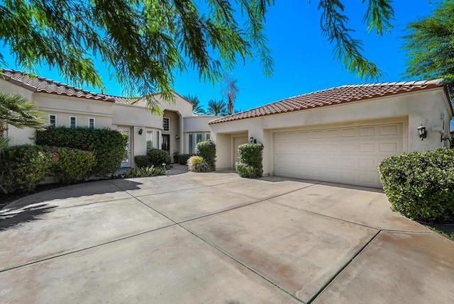 mediterranean / spanish-style house featuring a garage