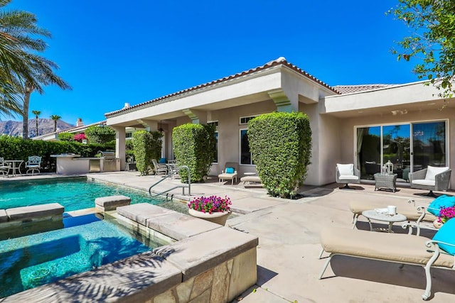 view of pool featuring an in ground hot tub and a patio