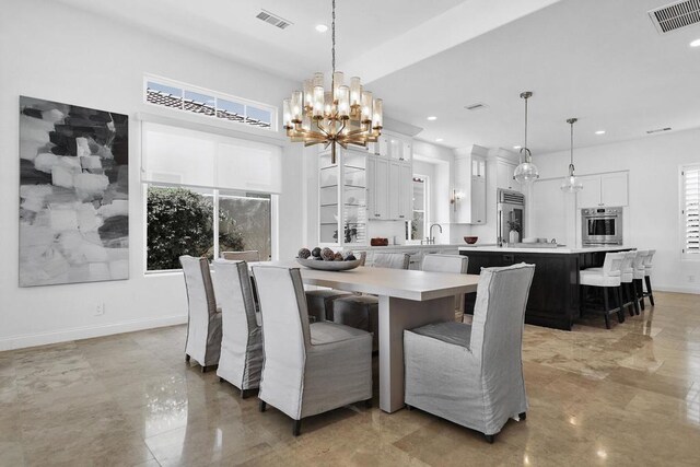 dining space featuring sink and a notable chandelier