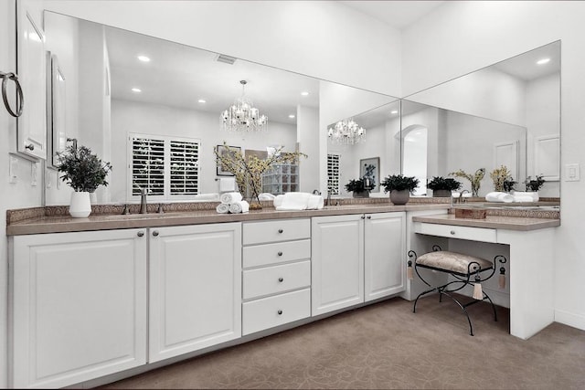 bathroom featuring vanity and an inviting chandelier