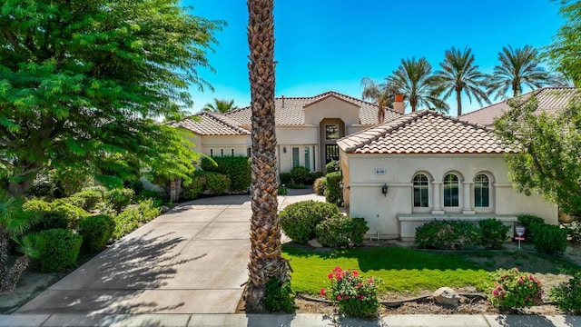 mediterranean / spanish house with a front lawn