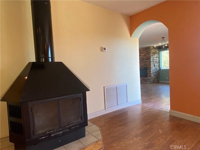 interior space with a fireplace, hardwood / wood-style flooring, and a notable chandelier