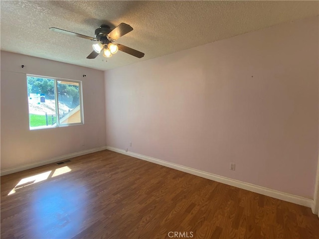 spare room with ceiling fan, wood-type flooring, and a textured ceiling