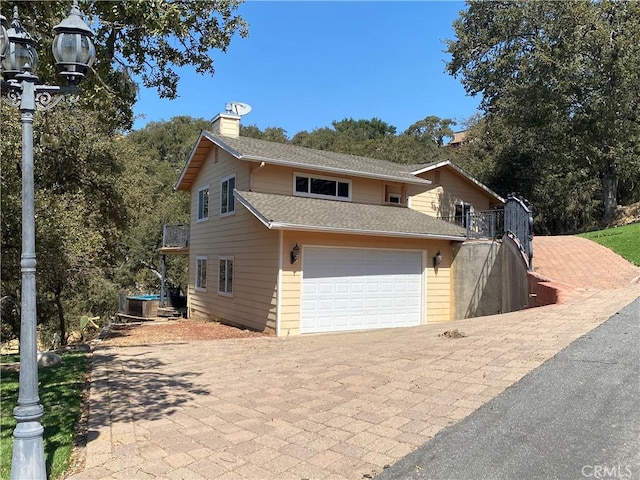 view of front property with central AC unit and a garage