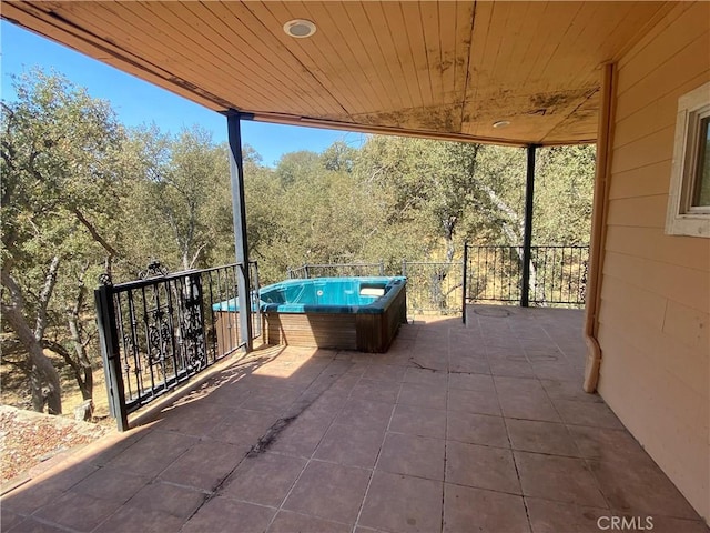 view of patio / terrace featuring an outdoor hot tub