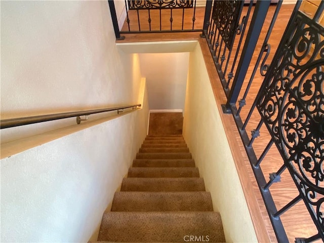 stairs featuring wood-type flooring