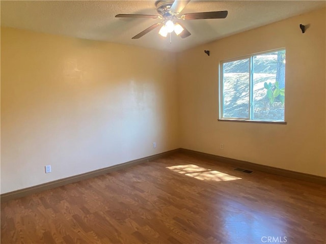 unfurnished room featuring hardwood / wood-style flooring and ceiling fan