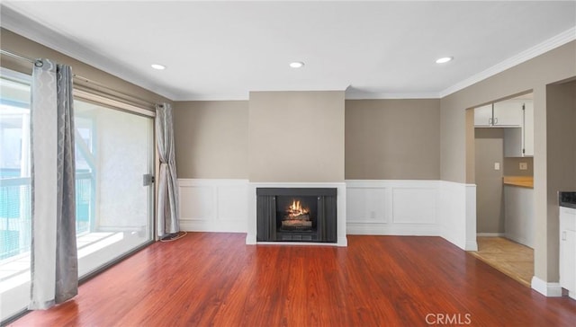 333 Burchett St Unit 308, Glendale, CA 91203 - unfurnished living room with ornamental molding, a multi sided fireplace, wood finished floors, wainscoting, and recessed lighting