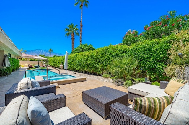 view of swimming pool featuring a mountain view and a patio area