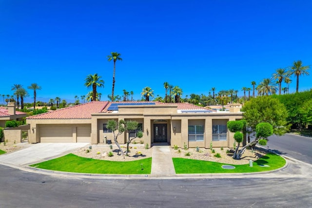 view of front of house featuring a garage and solar panels