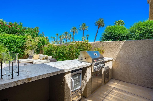 view of patio featuring area for grilling and an outdoor kitchen