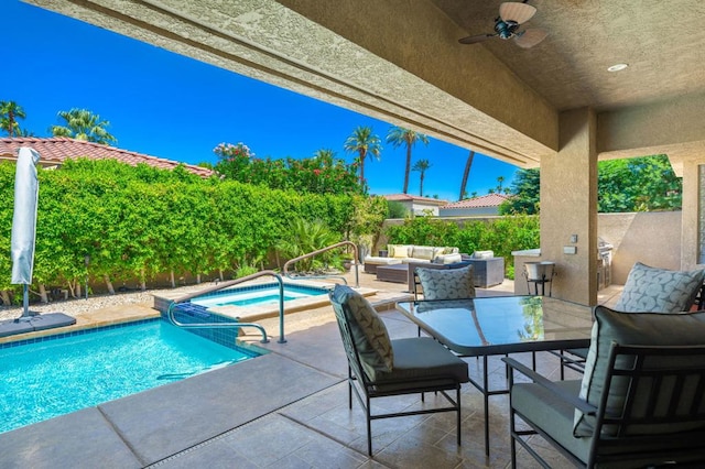 view of swimming pool featuring an in ground hot tub, a patio area, ceiling fan, and an outdoor living space