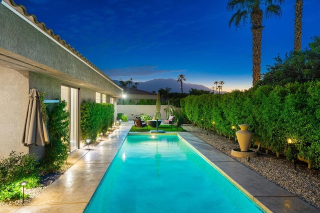 view of pool at dusk