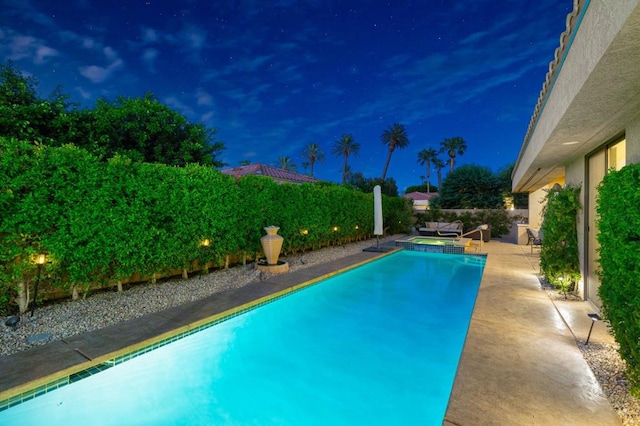 pool at night with a patio