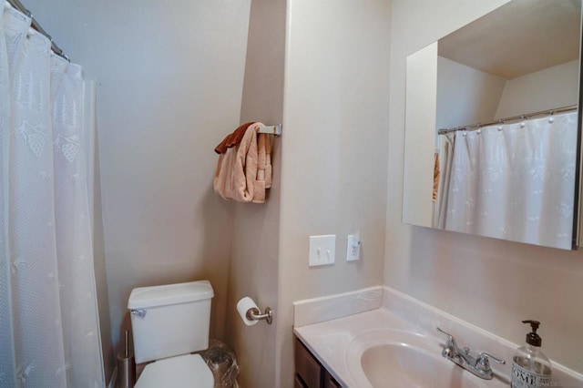 bathroom with vanity, toilet, and curtained shower