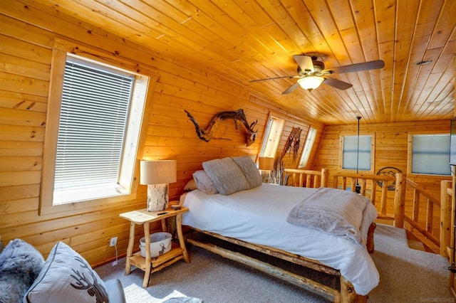 carpeted bedroom featuring ceiling fan, wooden walls, and wooden ceiling