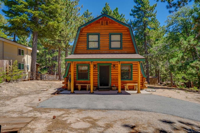 log home with covered porch