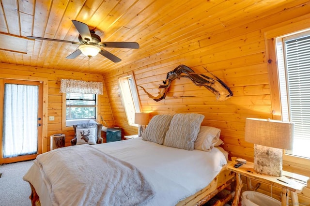 bedroom with ceiling fan, carpet floors, wooden walls, and wood ceiling