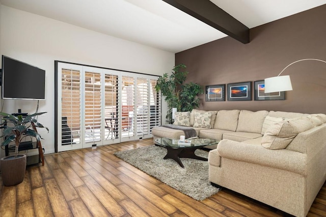 living room with beam ceiling and wood-type flooring