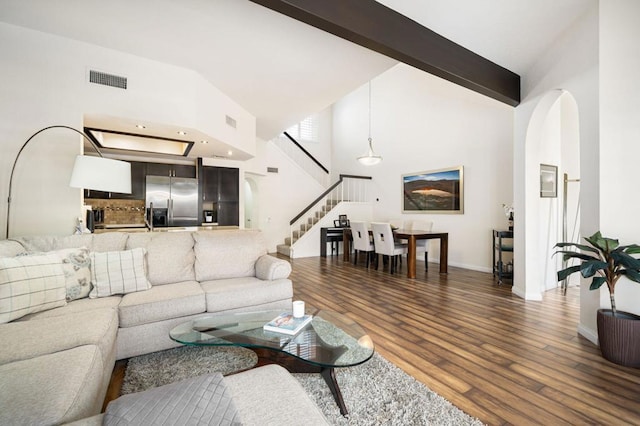 living room featuring high vaulted ceiling and hardwood / wood-style flooring