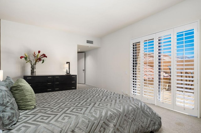 bedroom with carpet floors, access to outside, and multiple windows