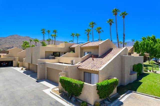 view of front of property featuring a mountain view and a garage