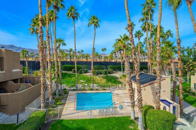 view of swimming pool featuring a mountain view and a patio