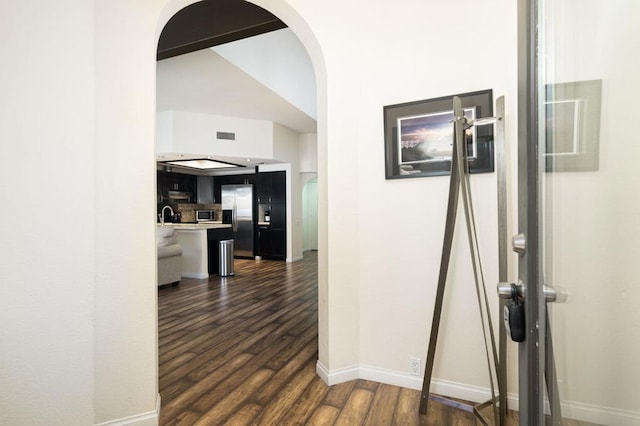 hall with dark hardwood / wood-style flooring and sink