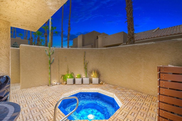 view of swimming pool featuring an in ground hot tub and a patio area