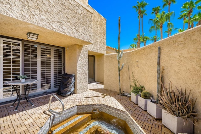 view of patio / terrace featuring a hot tub